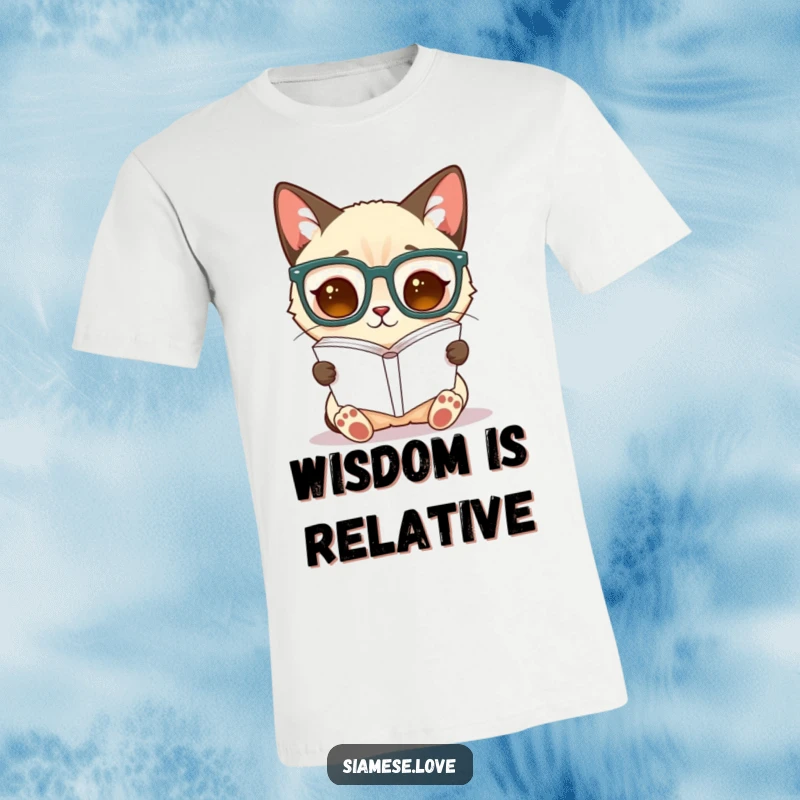 Funny Siamese cat t-shirt, a scholarly feline sports large glasses while attempting to read a book inverted.