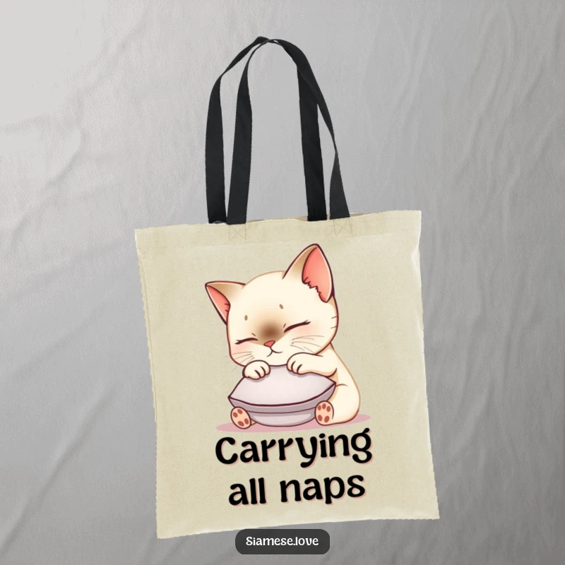 Funny Siamese cat tote bag featuring a cute kawaii kitty nuzzling a small cushion, perfect for carrying essentials with feline flair.