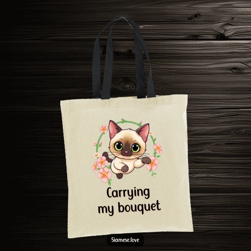 Funny tote bag with a curious Siamese cat leaping through a hoop of flowers, perfect for carrying essentials with feline grace and style.