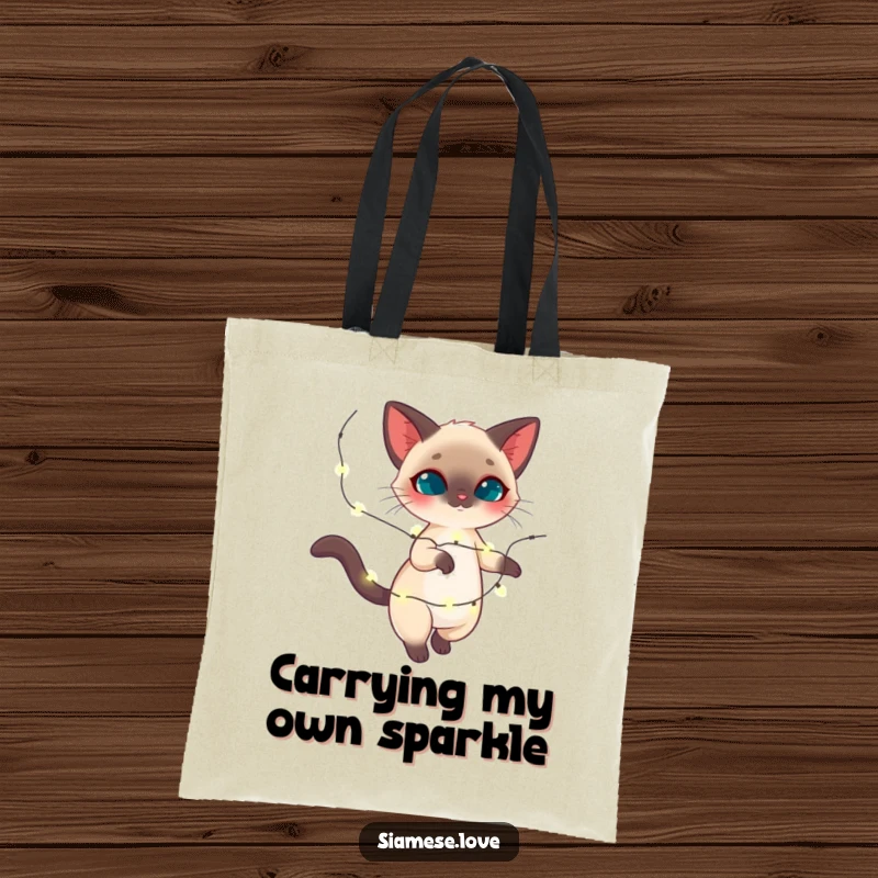 Funny Siamese cat tote bag, feline twirling with sparkling holiday lights, festive accessory, ideal funny gift.