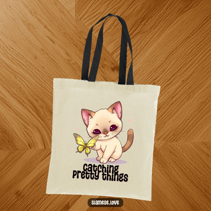 Funny Kawaii Siamese Cat Tote Bag: Cute tote showcasing a cat playfully pouncing on a shimmering butterfly.