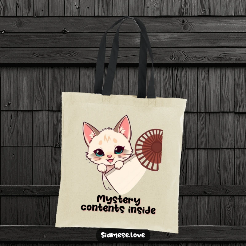 Funny Siamese cat tote bag, feline hiding behind a fan, peeking with a grin, mischievous accessory, ideal funny gift.