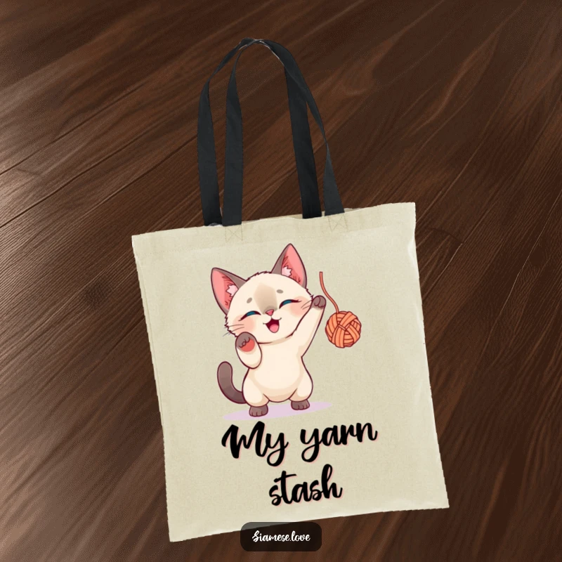 Funny Siamese Cat Tote Bag: A charming Siamese cat player caught in the act of batting a large ball of yarn.